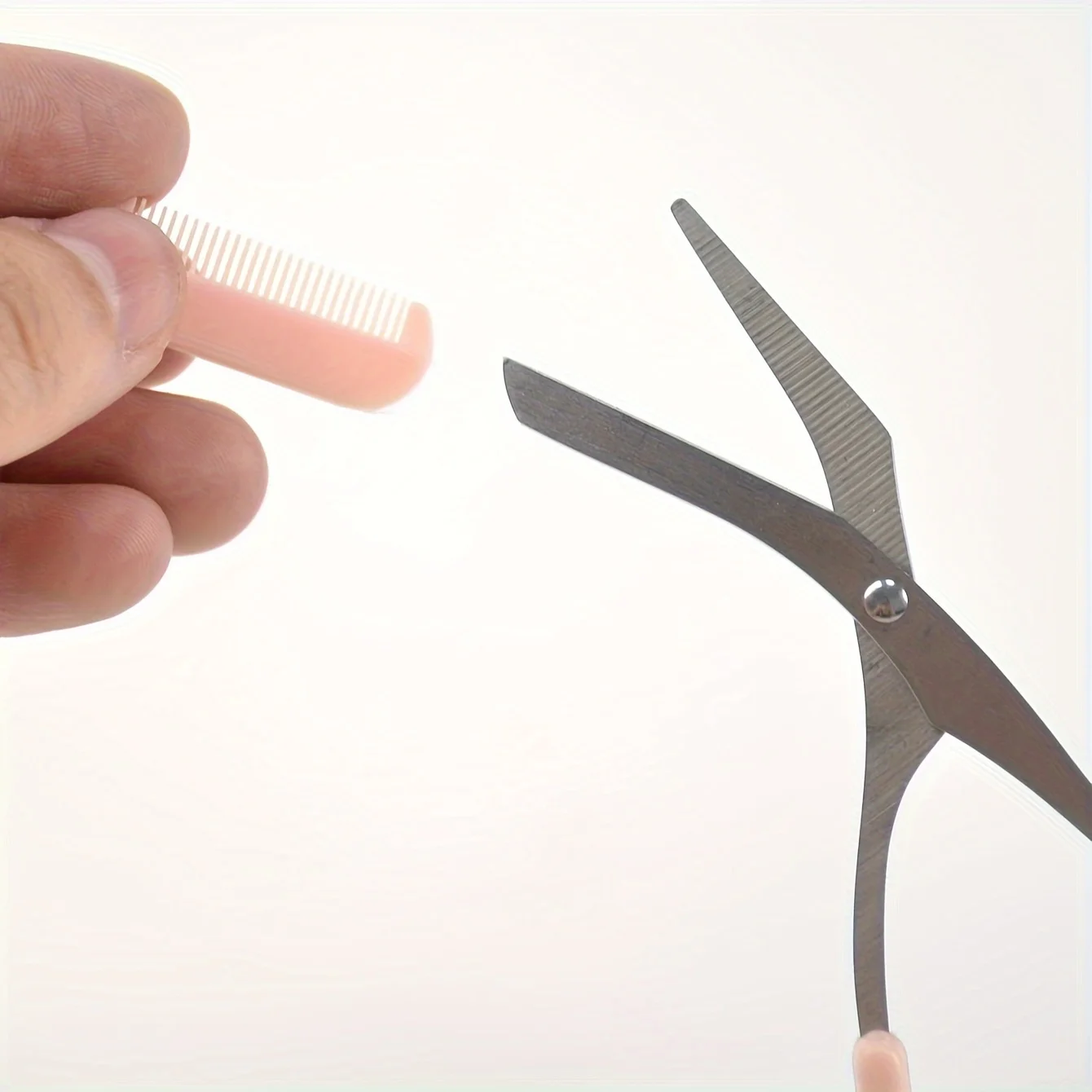 Pink eyebrow trimming scissors with built-in comb